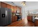 Open kitchen featuring wood cabinets, stainless steel appliances, and hardwood floors at 3760 Lake Point Blvd, Suwanee, GA 30024