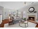 Cozy living room features a fireplace, hardwood floors, and comfortable seating adjacent to a breakfast nook at 3760 Lake Point Blvd, Suwanee, GA 30024