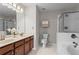 Primary bathroom featuring double sinks, a tub, and a glass-enclosed shower at 3760 Lake Point Blvd, Suwanee, GA 30024