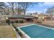 Aerial view of a covered in-ground pool behind a brick house on a sunny day at 3806 Lindley Cir, Powder Springs, GA 30127