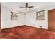 Neutral bedroom with two windows and red carpeting at 3806 Lindley Cir, Powder Springs, GA 30127