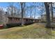 Home exterior featuring a brick facade, covered parking, and a well-maintained lawn at 3806 Lindley Cir, Powder Springs, GA 30127