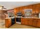 Kitchen area with wood cabinets, countertops, and laminate floors at 3806 Lindley Cir, Powder Springs, GA 30127