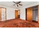 Spacious main bedroom featuring a ceiling fan, closet, and a connected bathroom at 3806 Lindley Cir, Powder Springs, GA 30127