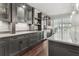 Stylish wet bar with gray cabinets, quartz countertops, designer fixtures, and a view of the property at 4434 Oglethorpe Nw Loop, Acworth, GA 30101