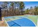 Brightly painted basketball court surrounded by trees provides outdoor recreation at 4434 Oglethorpe Nw Loop, Acworth, GA 30101