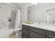 Modern bathroom with gray vanity, white marble tile surround tub and shower and Herringbone tile floors at 4434 Oglethorpe Nw Loop, Acworth, GA 30101