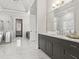 Elegant bathroom featuring marble floors, gray vanity, and a large mirror at 4434 Oglethorpe Nw Loop, Acworth, GA 30101