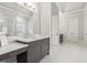 Stylish bathroom with marble floors, gray vanity cabinets, and a glass-enclosed shower at 4434 Oglethorpe Nw Loop, Acworth, GA 30101