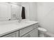 Modern bathroom with gray vanity, large mirror, and marble-walled shower at 4434 Oglethorpe Nw Loop, Acworth, GA 30101