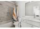 Bright bathroom with a tub and shower combo, a marble tiled wall, and a white vanity at 4434 Oglethorpe Nw Loop, Acworth, GA 30101