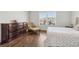 Bedroom featuring dark wood floors, large dresser, and a comfy chair near a bright window at 4434 Oglethorpe Nw Loop, Acworth, GA 30101