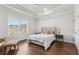 Bedroom with hardwood floors, a large window, and a decorative tray ceiling with ceiling fan at 4434 Oglethorpe Nw Loop, Acworth, GA 30101