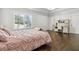 Bright bedroom showcases a window, dark wood floors, and a stylish writing desk at 4434 Oglethorpe Nw Loop, Acworth, GA 30101