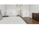 Bedroom showcasing wood floors, a dresser, and white doors leading to other rooms at 4434 Oglethorpe Nw Loop, Acworth, GA 30101