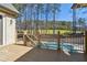 Spacious wooden deck offering a view of a swimming pool, wooded backyard and golf course at 4434 Oglethorpe Nw Loop, Acworth, GA 30101