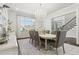 Bright dining room featuring an oval table, chandelier, and a large window at 4434 Oglethorpe Nw Loop, Acworth, GA 30101