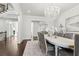 Dining room with hardwood floors, chandelier, and view of the living room with fireplace at 4434 Oglethorpe Nw Loop, Acworth, GA 30101