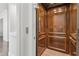 An elevator with wood paneling and tile floor providing convenient access to different levels of the home at 4434 Oglethorpe Nw Loop, Acworth, GA 30101