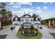 Elegant community entryway with a circular driveway and decorative landscaping at 4434 Oglethorpe Nw Loop, Acworth, GA 30101