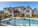 The rear view of a stately brick home, showcasing a custom pool, hot tub and outdoor living spaces at 4434 Oglethorpe Nw Loop, Acworth, GA 30101