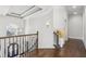 Elegant entryway featuring hardwood floors, iron railing staircase and tray ceiling with modern light fixture at 4434 Oglethorpe Nw Loop, Acworth, GA 30101