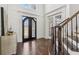 Bright foyer with dark wood floors and a view of the ornate front doors and staircase at 4434 Oglethorpe Nw Loop, Acworth, GA 30101