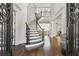 Grand foyer with a curved staircase, hardwood floors, and elegant architectural details at 4434 Oglethorpe Nw Loop, Acworth, GA 30101