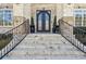 Ornate front entrance with stone steps, wrought iron railings, and decorative potted plants at 4434 Oglethorpe Nw Loop, Acworth, GA 30101