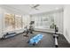 Brightly lit home gym with large windows, equipped with bike, rowing machine, weights and exercise mat at 4434 Oglethorpe Nw Loop, Acworth, GA 30101