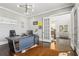 Bright office featuring a modern desk, hardwood floors, and stylish French doors leading to the foyer at 4434 Oglethorpe Nw Loop, Acworth, GA 30101
