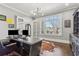 Well-lit office with hardwood flooring, a modern desk, large windows and elegant French doors at 4434 Oglethorpe Nw Loop, Acworth, GA 30101