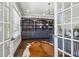 Inviting home office with custom built-ins, hardwood floors, and an elegant cowhide rug at 4434 Oglethorpe Nw Loop, Acworth, GA 30101