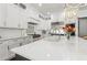 Modern kitchen featuring a large island, white cabinets, stainless steel appliances, and sleek countertops at 4434 Oglethorpe Nw Loop, Acworth, GA 30101