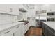 Elegant kitchen featuring custom cabinets, stainless appliances, and a stone backsplash at 4434 Oglethorpe Nw Loop, Acworth, GA 30101