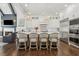 Gourmet kitchen featuring white cabinets, stainless steel appliances, and a large center island with seating at 4434 Oglethorpe Nw Loop, Acworth, GA 30101