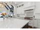 Bright kitchen featuring a large island with white countertop, modern appliances, and white backsplash at 4434 Oglethorpe Nw Loop, Acworth, GA 30101