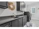 Well-organized laundry room with gray cabinets, countertop space, and modern washer and dryer at 4434 Oglethorpe Nw Loop, Acworth, GA 30101