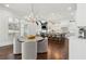 Open-concept kitchen and breakfast nook with modern lighting fixtures and dark wood floors at 4434 Oglethorpe Nw Loop, Acworth, GA 30101