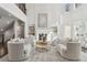 Bright, airy living room featuring a soaring fireplace, neutral furnishings, and large windows at 4434 Oglethorpe Nw Loop, Acworth, GA 30101