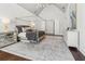 Spacious main bedroom with canopy bed, decor, and hardwood floors featuring a gray and white rug at 4434 Oglethorpe Nw Loop, Acworth, GA 30101