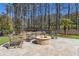 Stone patio featuring a beautiful stone fire pit and seating with wooded backdrop at 4434 Oglethorpe Nw Loop, Acworth, GA 30101