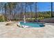This backyard features a luxurious pool and spa, surrounded by well-manicured landscaping and stone pavers at 4434 Oglethorpe Nw Loop, Acworth, GA 30101
