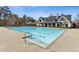 Large swimming pool with steps leads to a clubhouse with outdoor seating, perfect for relaxation and entertainment at 4434 Oglethorpe Nw Loop, Acworth, GA 30101
