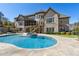 Gorgeous pool and spa with stone patio and beautiful brick home in the background at 4434 Oglethorpe Nw Loop, Acworth, GA 30101