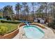 Outdoor pool features a blue waterslide surrounded by lush landscaping and a brick retaining wall at 4434 Oglethorpe Nw Loop, Acworth, GA 30101