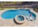 An aerial view of a sparkling blue swimming pool and hot tub surrounded by stone pavers at 4434 Oglethorpe Nw Loop, Acworth, GA 30101