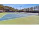 Well-maintained tennis court with net and trees along the fence offers recreational opportunities for residents at 4434 Oglethorpe Nw Loop, Acworth, GA 30101