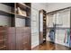 Bright walk-in closet with custom wood shelving, drawers, and hanging racks providing organized storage solutions at 4434 Oglethorpe Nw Loop, Acworth, GA 30101