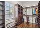 Spacious walk-in closet features dark wood shelves, drawers, and clothing racks, offering ample storage at 4434 Oglethorpe Nw Loop, Acworth, GA 30101